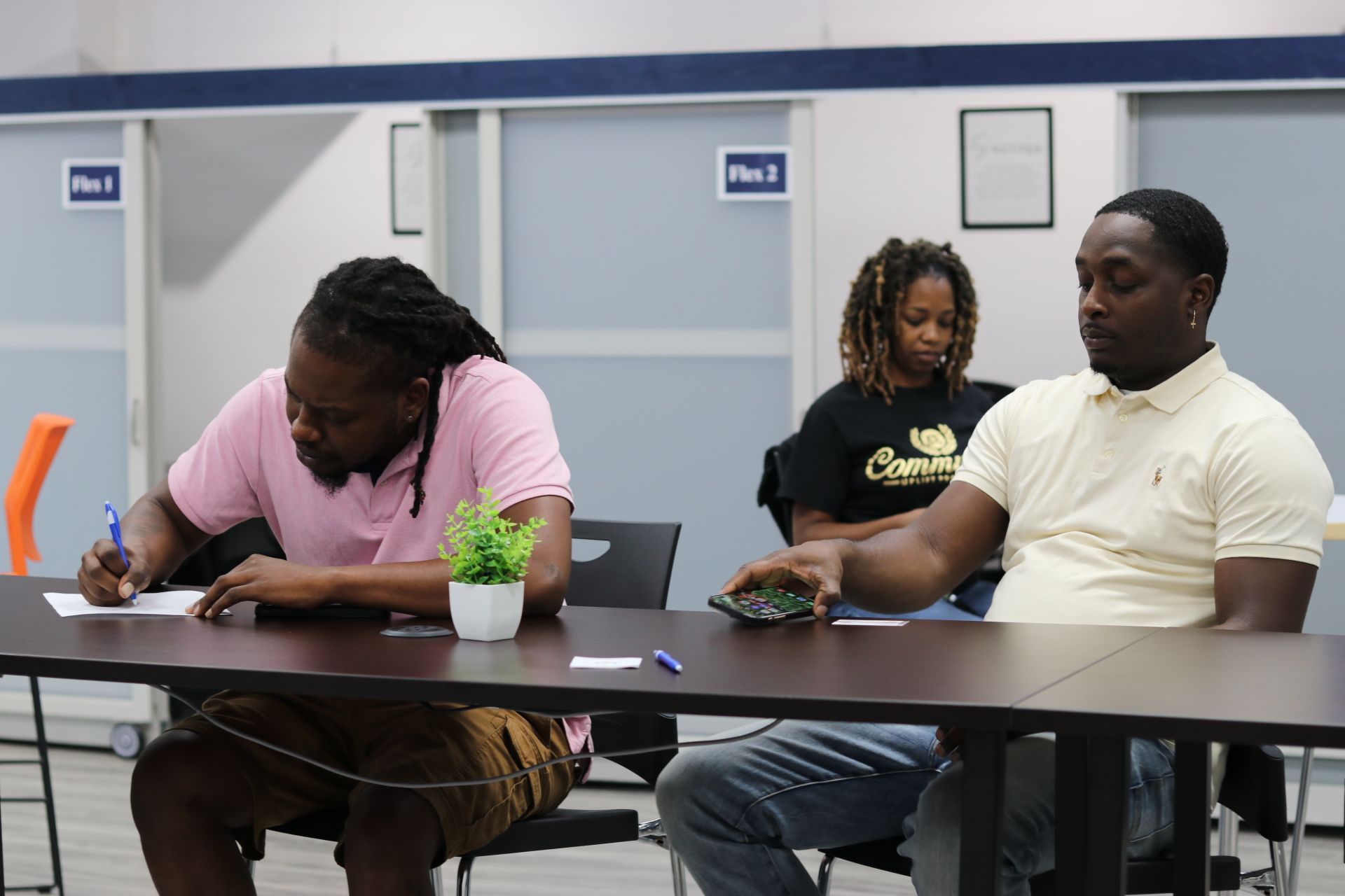 Attendees taking notes during a business workshop